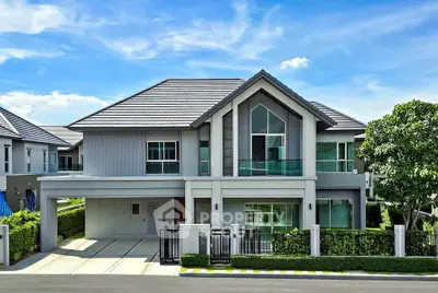 Stunning modern two-story house with sleek design and lush greenery