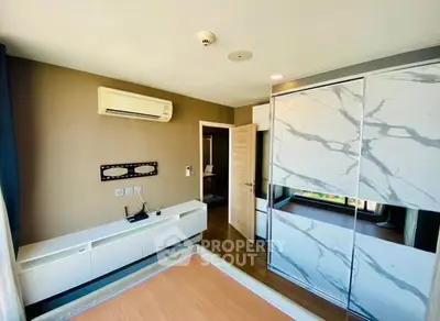 Modern bedroom with built-in wardrobe and air conditioning unit