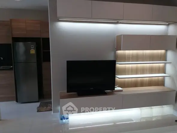 Modern living room with sleek TV unit and ambient lighting
