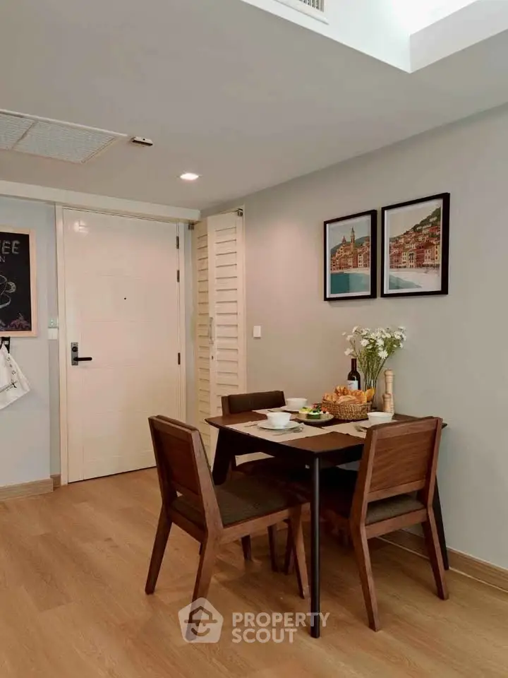 Charming dining area with wooden table and chairs, modern decor, and cozy ambiance in a stylish apartment.