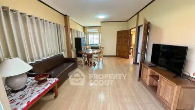 Spacious living room with modern furnishings and natural light, ideal for relaxation and entertainment.