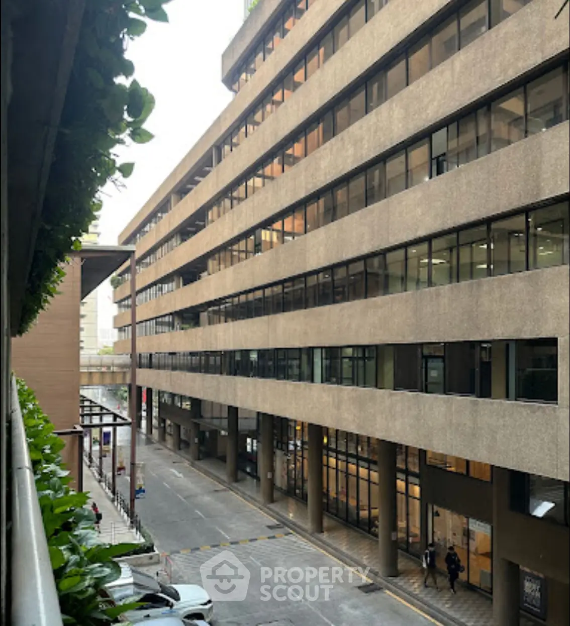 Modern office building exterior with large windows and street view