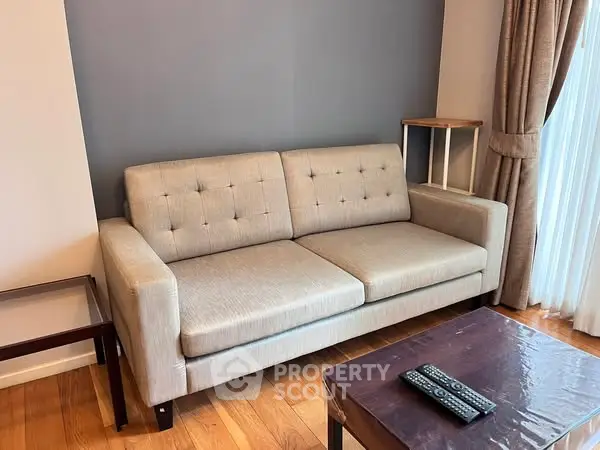 Cozy living room with modern beige sofa and wooden coffee table