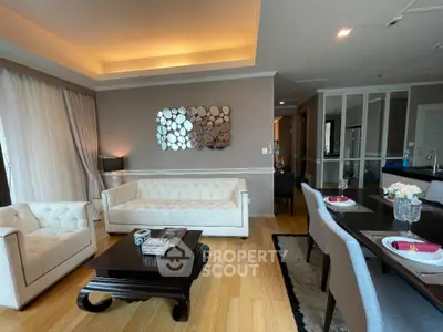 Elegant living room with modern decor and dining area, featuring stylish furniture and ambient lighting.