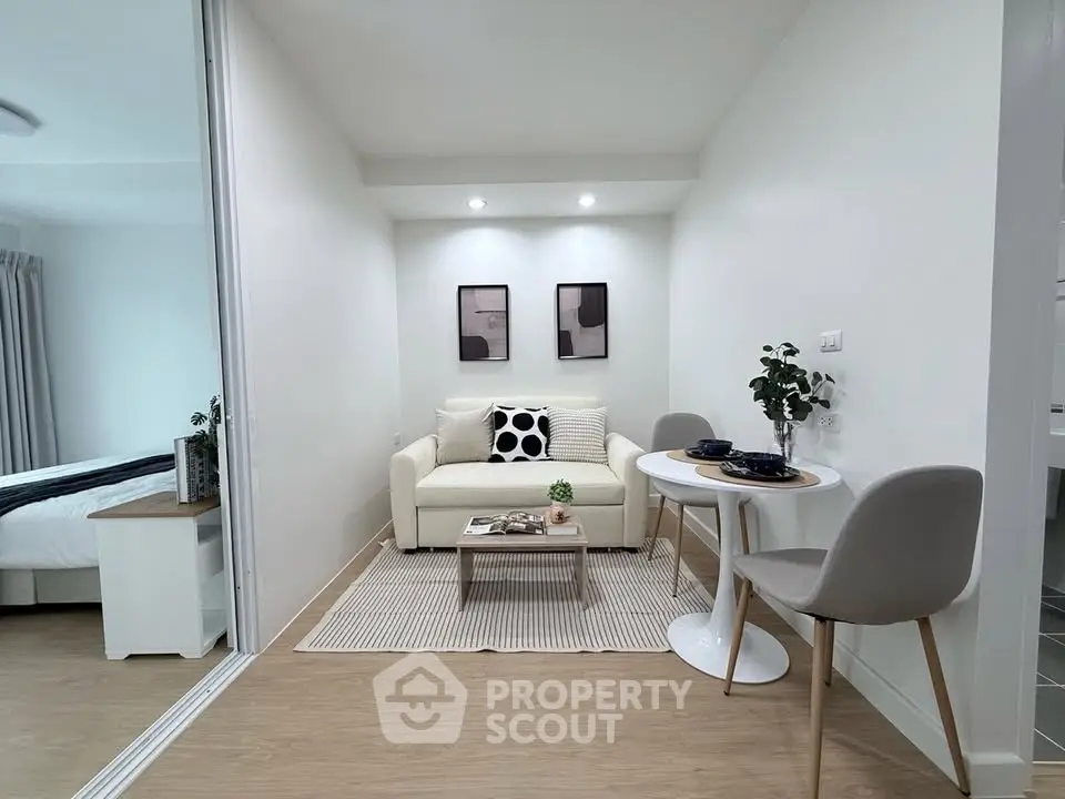 Modern living room with cozy seating and dining area in a stylish apartment.