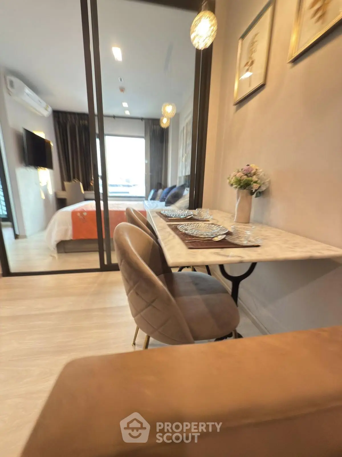 Modern apartment interior with cozy dining area and stylish bedroom view.