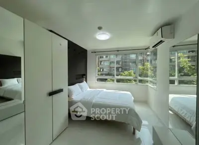 Bright modern bedroom with large windows and minimalist decor