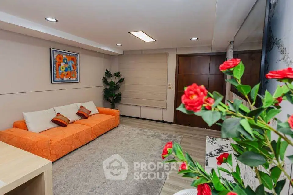 Stylish living room with vibrant orange sofa and modern decor