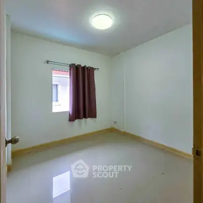 Spacious empty bedroom with window and curtain, ready for customization.