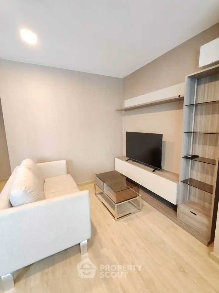 Modern living room with sleek furniture and mounted TV, perfect for relaxation and entertainment.