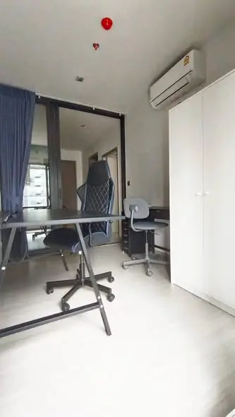 Modern study room with sleek desk and ergonomic chair, featuring air conditioning and ample natural light.