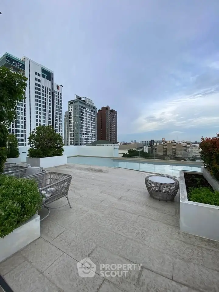 Stunning rooftop terrace with city views and modern seating area, perfect for relaxation and entertainment.