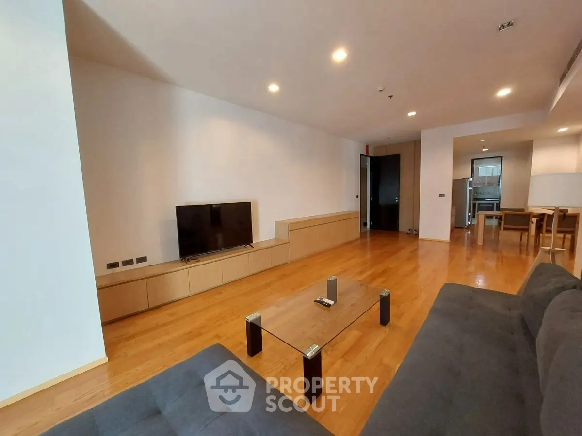 Spacious modern living room with wooden flooring and sleek furniture