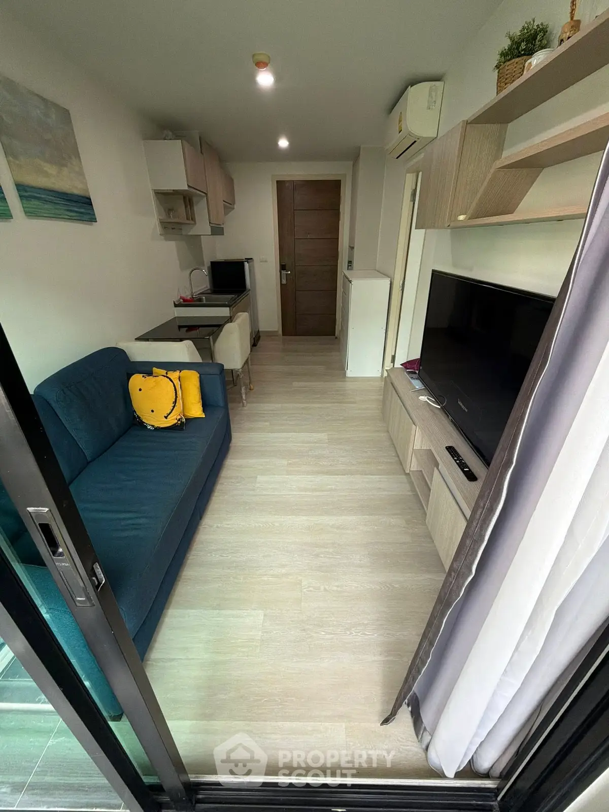 Modern living room with sleek furniture and large TV, perfect for cozy relaxation and entertainment.