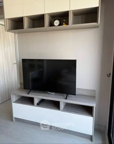 Modern living room with sleek TV stand and wall-mounted shelves