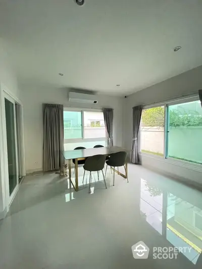 Spacious dining area with large windows and modern furnishings