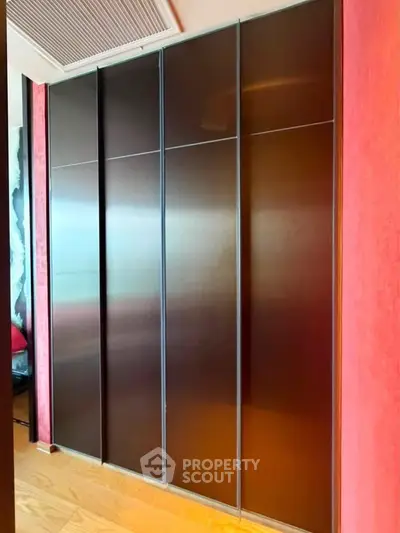 Sleek modern wardrobe with sliding doors in a stylish interior setting.