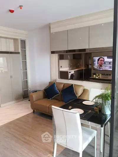 Modern living room with stylish furniture and open kitchen layout in a contemporary apartment.