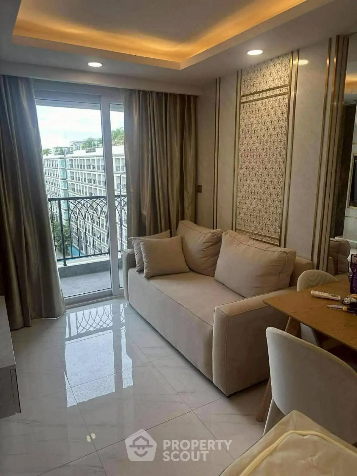 Elegant living room with modern sofa and balcony view in luxury apartment.