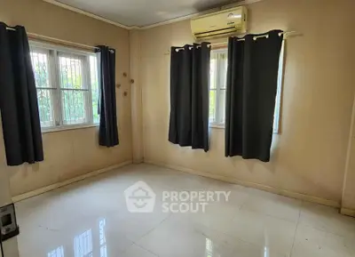 Spacious room with large windows and air conditioning, perfect for a cozy living space.