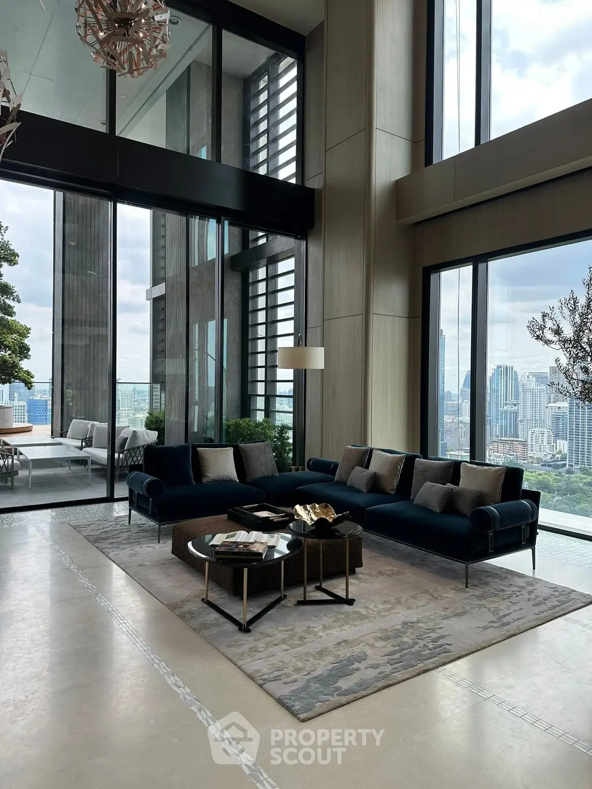 Luxurious high-rise living room with floor-to-ceiling windows and stunning city views.