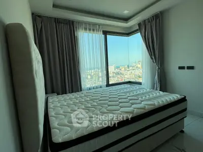Modern bedroom with panoramic city view and elegant curtains