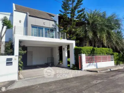 Modern two-story house with lush greenery and spacious driveway