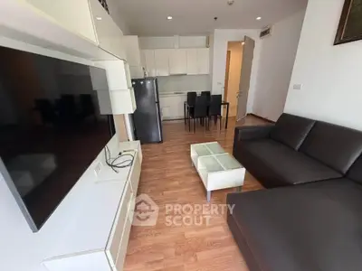 Modern living room with sleek furniture and open kitchen layout