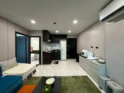 Modern living room with open kitchen layout and sleek design