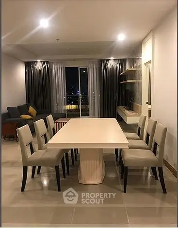 Spacious dining area with elegant table and chairs in modern apartment