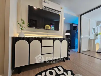 Modern living room with stylish TV cabinet and air conditioning, featuring sleek decor and cozy ambiance.