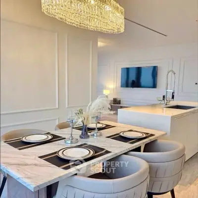 Luxurious dining area with elegant chandelier and modern kitchen island