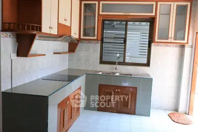 Charming kitchen with closed layout and modern fixtures, ideal for culinary enthusiasts.