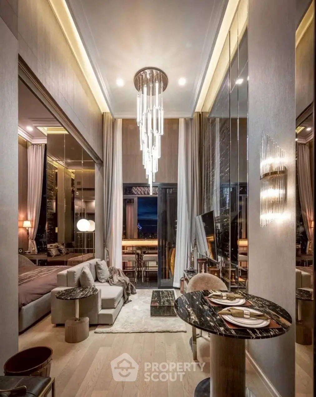 Luxurious high-ceiling living room with elegant chandelier and modern decor