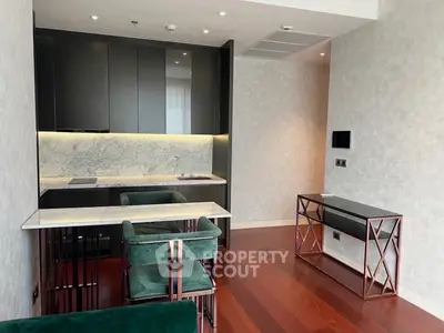 Modern kitchen with sleek design, marble backsplash, and elegant dining area in luxury apartment.