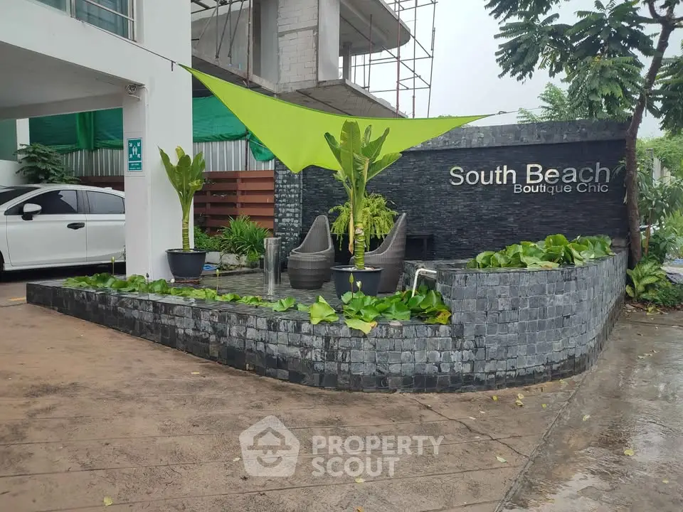 Chic boutique hotel entrance with modern design and lush greenery