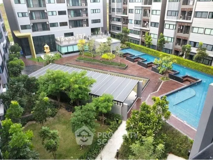 Modern condominium complex with lush garden and inviting swimming pool