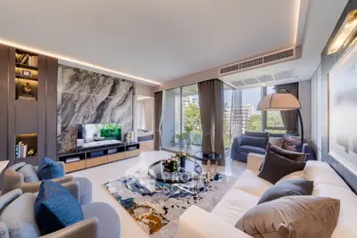 Luxurious modern living room with elegant decor and large windows offering stunning city views.