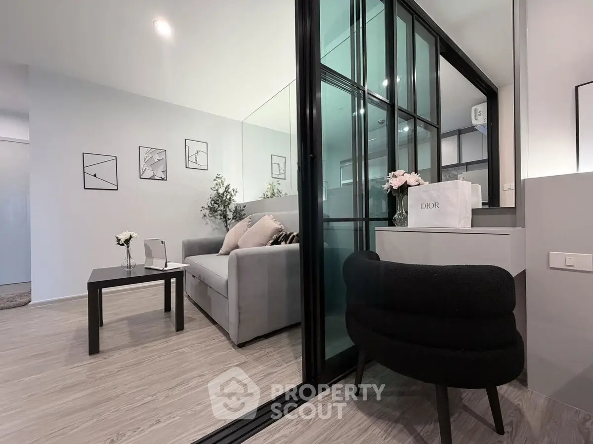 Modern living room with glass partition and stylish decor