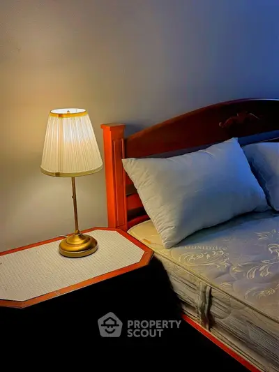 Cozy bedroom with elegant wooden bed and soft lighting