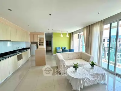 Spacious modern living room with open kitchen and large windows in a bright apartment.
