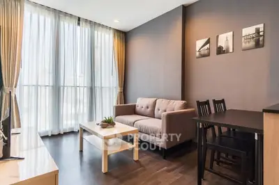 Modern living room with stylish decor and natural light in a contemporary apartment.