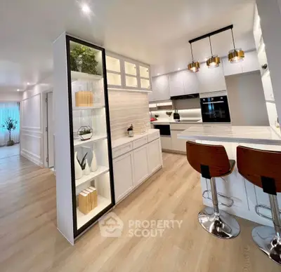 Modern kitchen with sleek design, featuring an open layout, stylish lighting, and contemporary appliances.