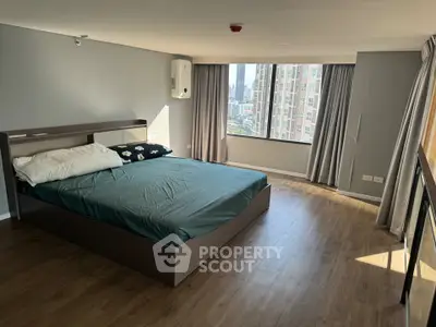 Spacious bedroom with city view and modern decor in high-rise apartment