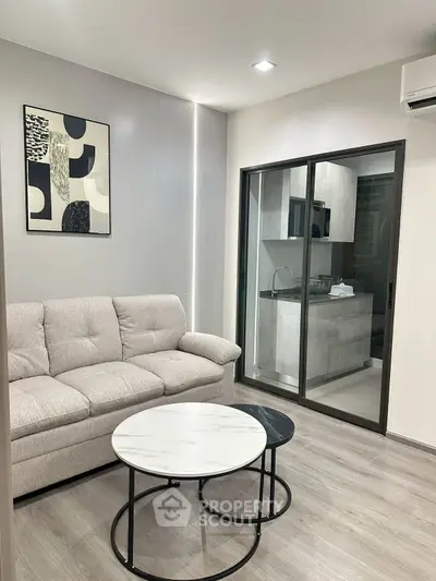 Modern living room with cozy sofa and stylish kitchen view