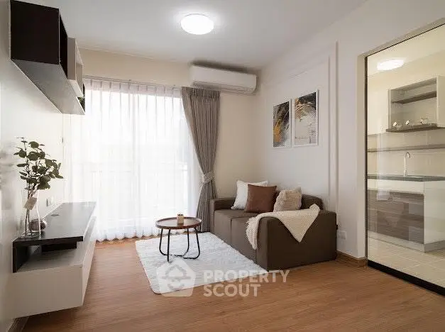 Modern living room with cozy sofa, stylish decor, and natural light from large window.