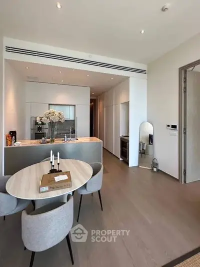 Modern kitchen with sleek design and dining area in luxury apartment
