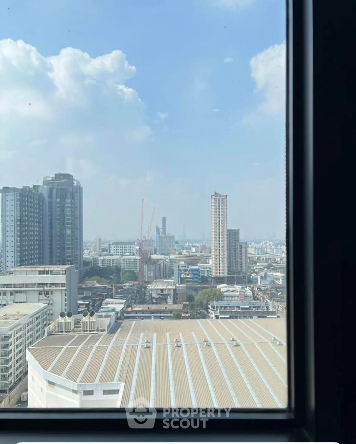Stunning cityscape view from high-rise window showcasing urban skyline.
