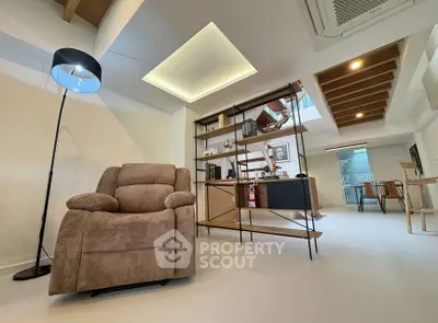 Modern living room with cozy armchair and stylish shelving unit