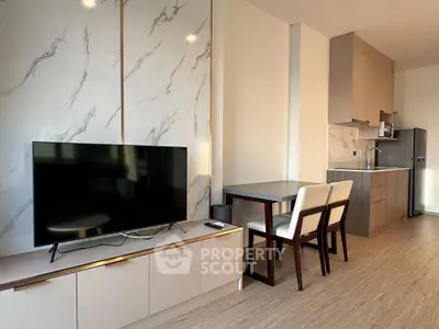 Modern living room with sleek TV unit and stylish kitchen area